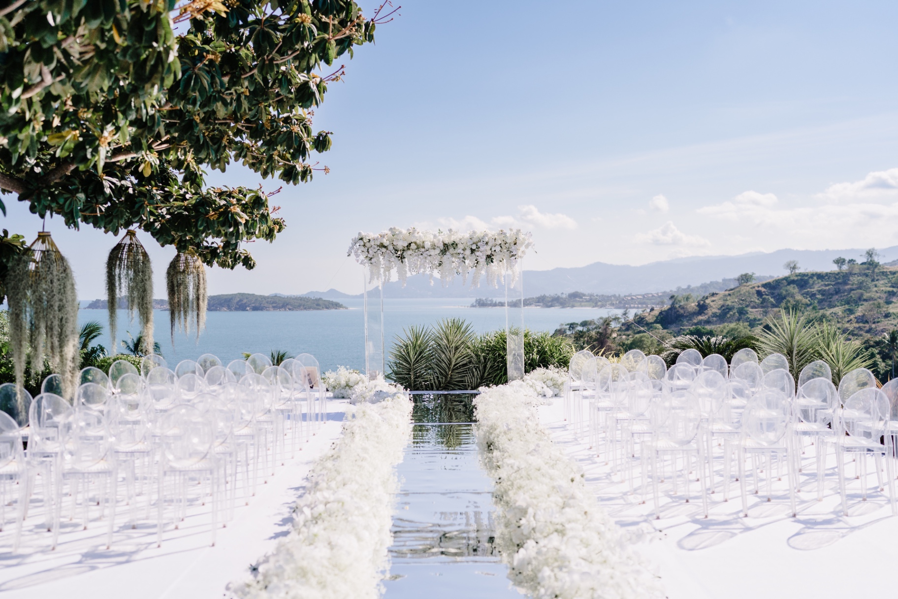 White-floral wedding ceremony with sea views