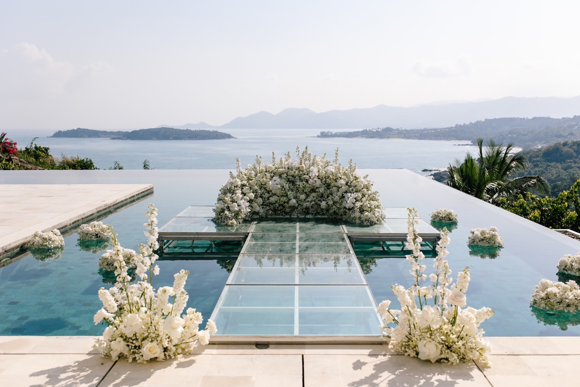 Pool-stage ceremony with white floral arrangement